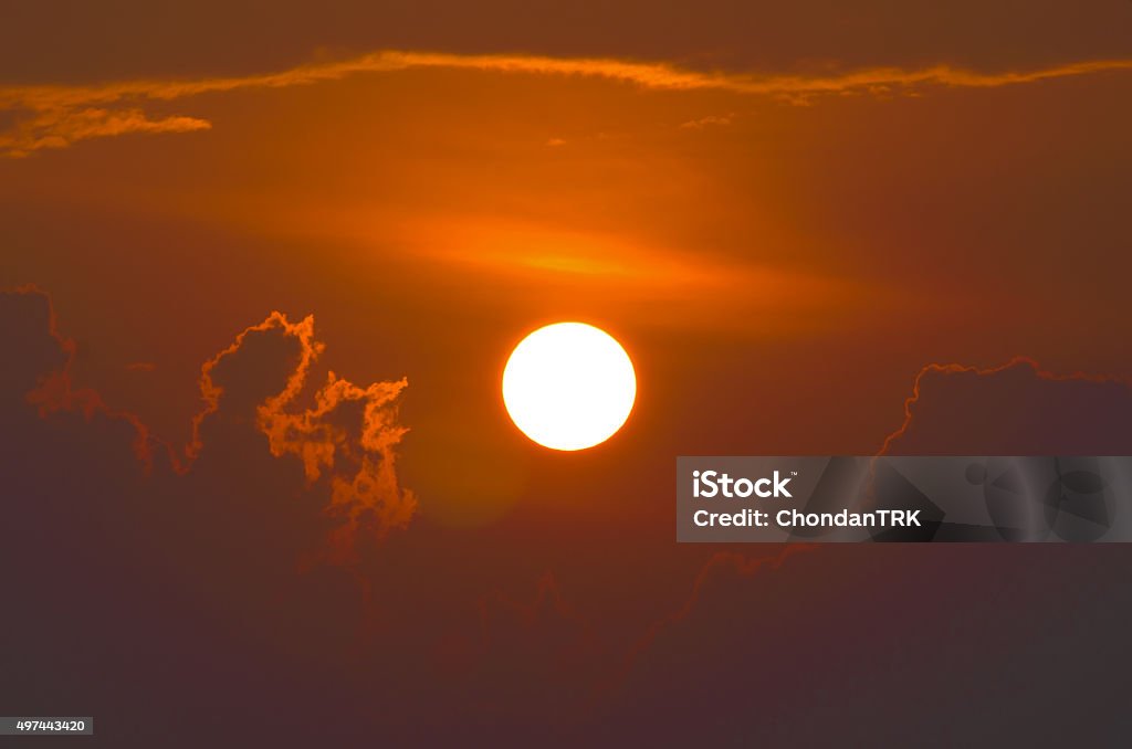 Bright big sun in a cloudy sky Backgrounds Stock Photo