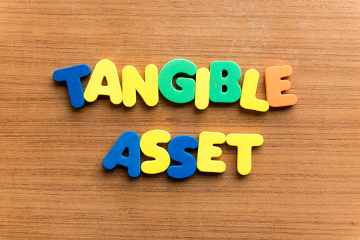 tangible asset  colorful word on the wooden background