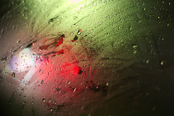 istock Light effects on a wet glass pane with water drops 497444462