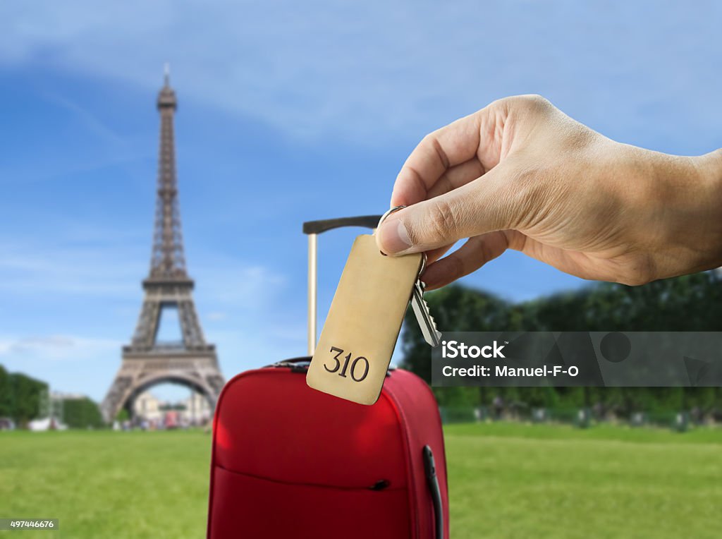 get a hotel in paris guest holding the hotel room key at Paris with Eiffel Tower in the background 2015 Stock Photo