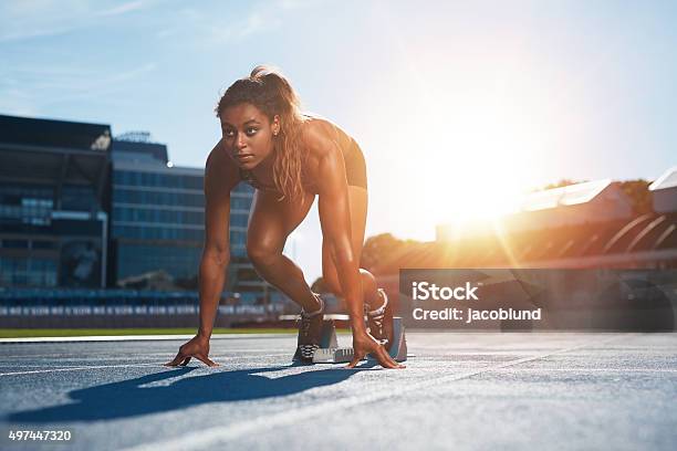 Woman About To Start A Sprint Stock Photo - Download Image Now - Running, Athlete, Sprinting