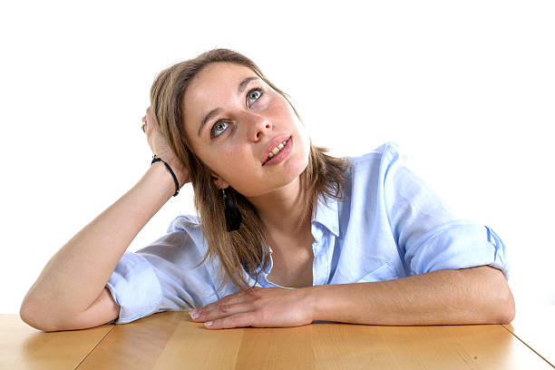 istock young woman lost in thought 497448515