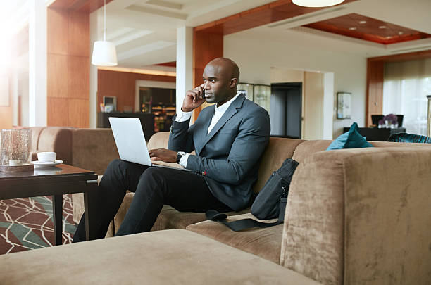 istock Businessman in hotel lobby using mobile phone 497448720