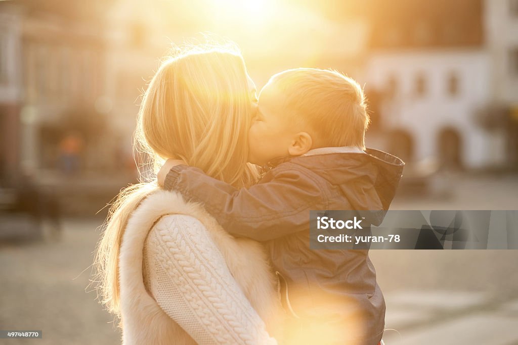 Happiness mother and son on the street at sunny day. 2015 Stock Photo