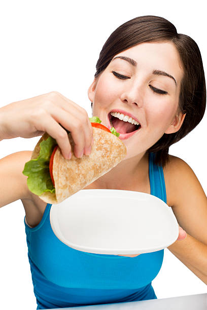 istock Cheerful woman eating healthy taco 497450137