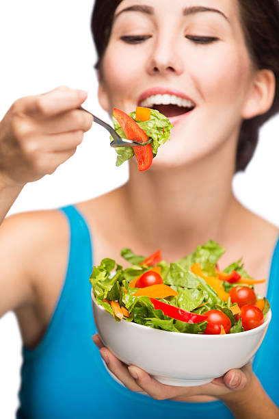istock Hispanic woman eating salad 497450147