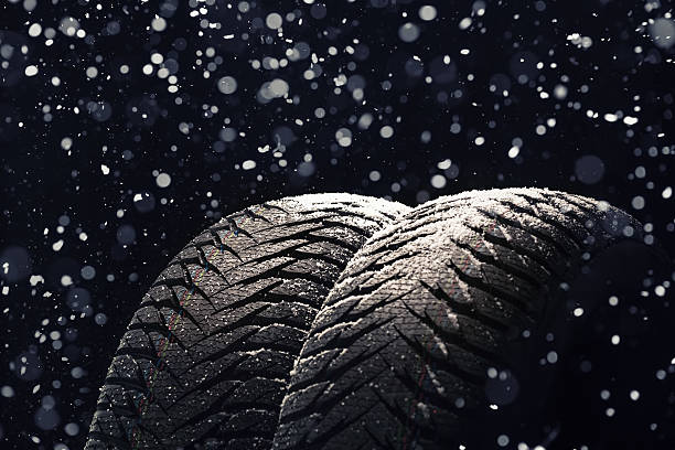 istock Winter Car tires with snow on black 497450666