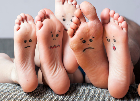 Human soles with painted faces close-up. Concept of feet care.