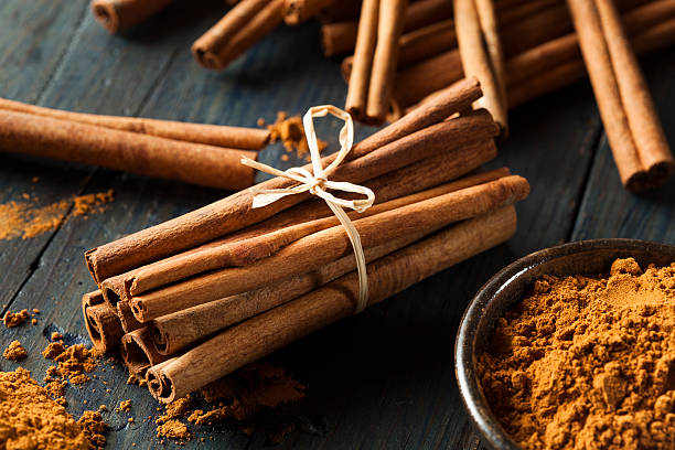 Organic Raw Brown Cinnamon Organic Raw Brown Cinnamon on a Background stick plant part photos stock pictures, royalty-free photos & images