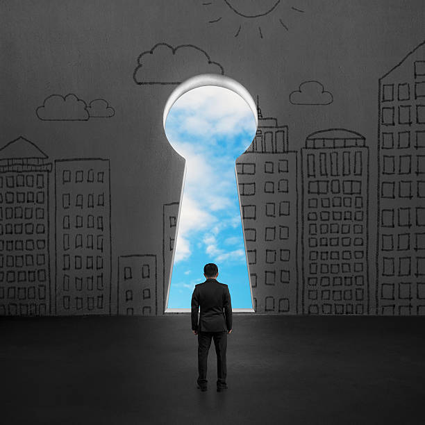 istock Man standing in front of key door on wall 497466771