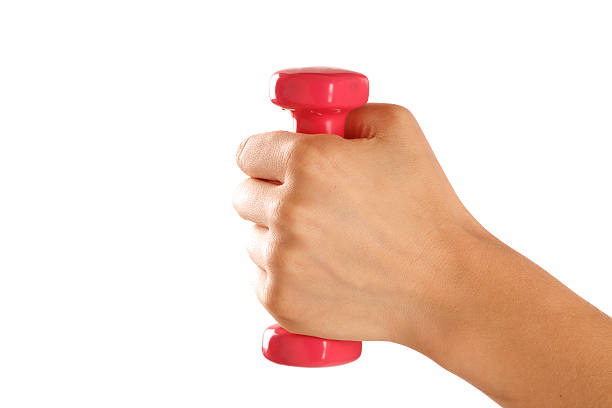 istock Beautiful Female hand holding a pink barbell 497468893