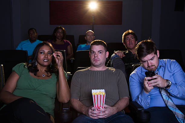 istock Annoyed guy in movie theatre 497469339
