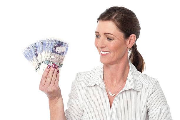 Woman making fan of pound sterling banknotes stock photo