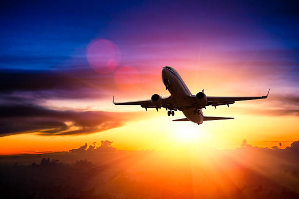 istock Airplane in the sky at sunrise 497471005
