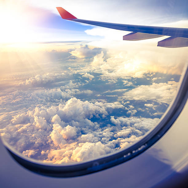 istock Clouds and sky as seen through window of an aircraft 497472009