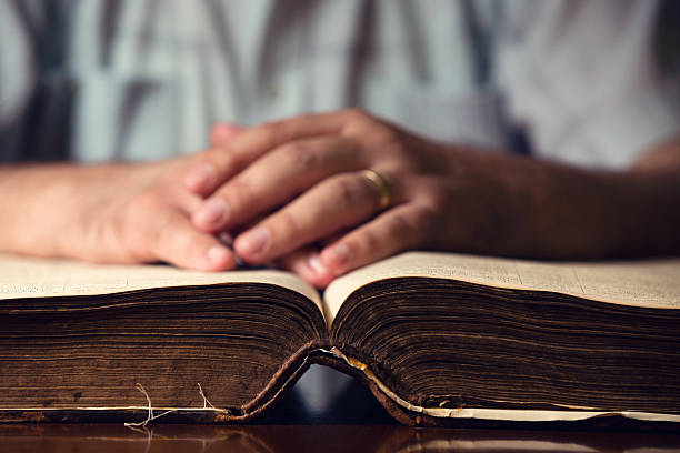 istock Male Hand On Open Bible 497472251