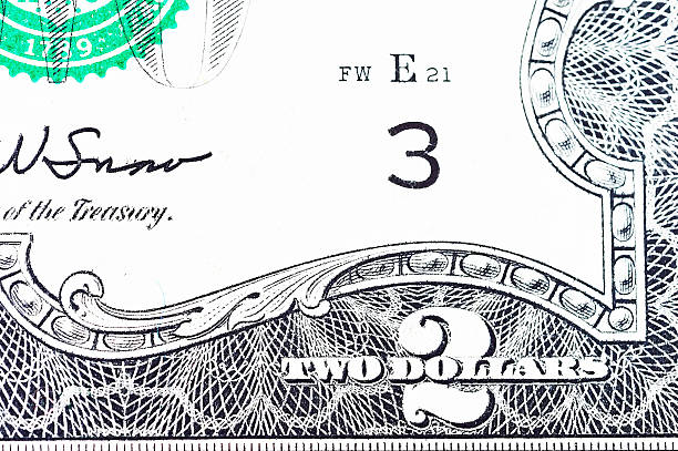 istock two dollars bills isolated on white background, macro shot 497472893