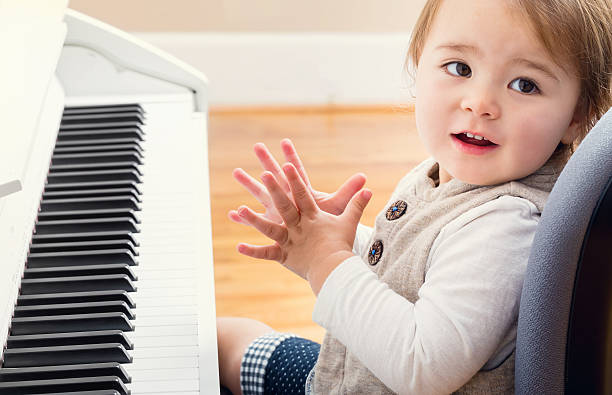 istock Happy toddler girl playing piano 497481894