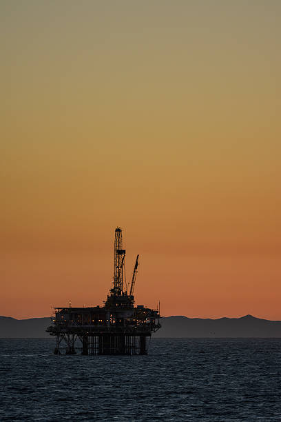 istock Oil Rig Silhouette at Sunset 497482138