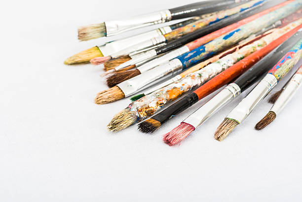 istock Old Used Artist Brushes on White Canvas Background Right View 497482142