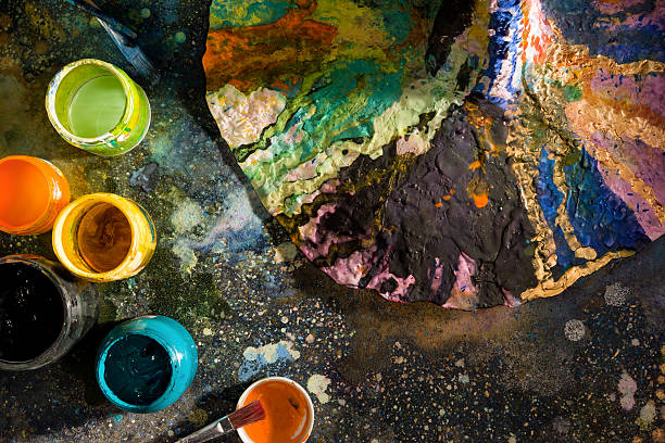 istock The artist's palette, next to cans of paint 497482204