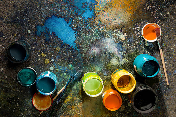 Table artist spattered with paint, paint cans close