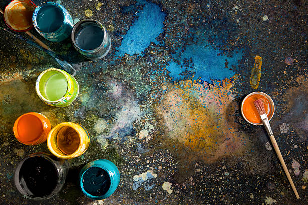 istock Table artist spattered with paint, paint cans close 497482962