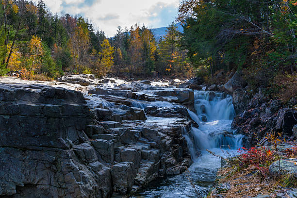 istock Rocky Waterfall and Autumn Colors 497483426