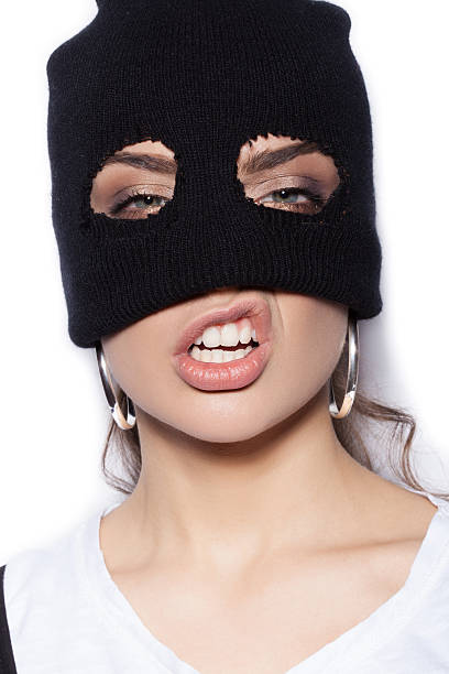 sexy girl in balaclava - crime and violence stock photo