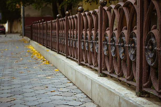 istock Iron fence near the sidewalk 497485632