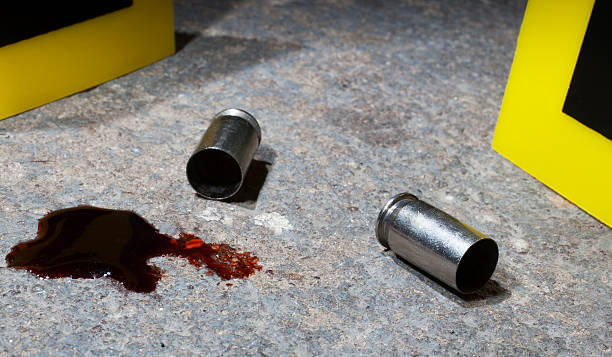 Bloody crime scene Blood and empty handgun ammo with evidence markers on concrete Silver Bullet stock pictures, royalty-free photos & images