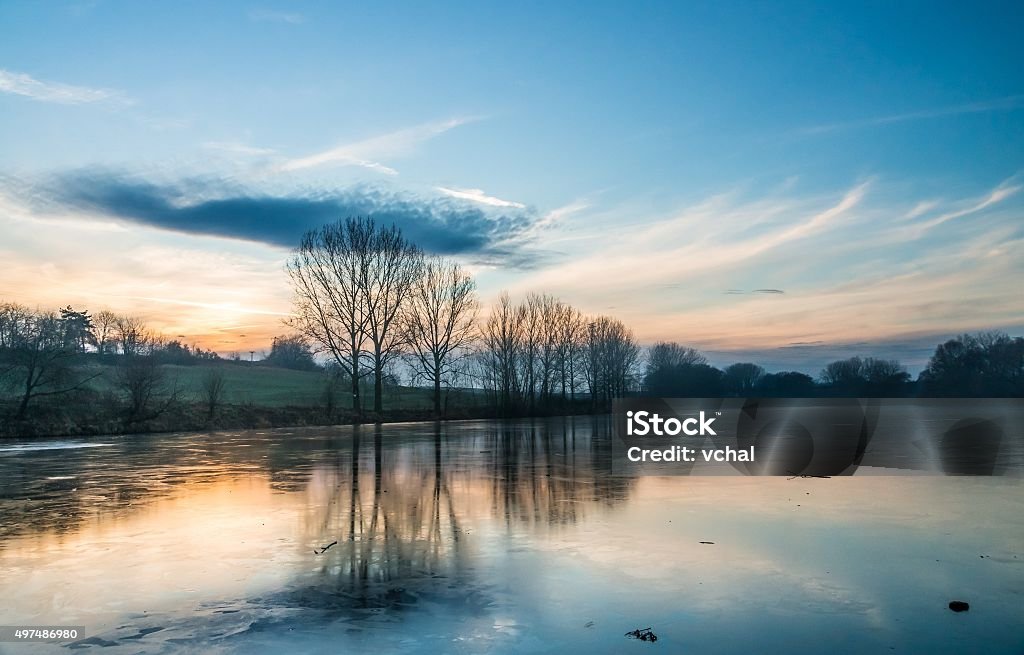 Frozen and icy pond at evening in winter Frozen and icy lake at evening in winter 2015 Stock Photo