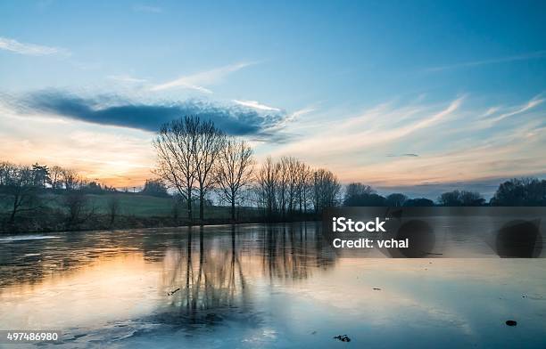 Frozen And Icy Pond At Evening In Winter Stock Photo - Download Image Now - 2015, Dawn, Dusk