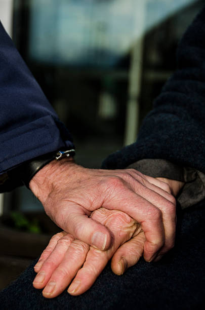 istock Senior married couple holding hands closeup 497487842