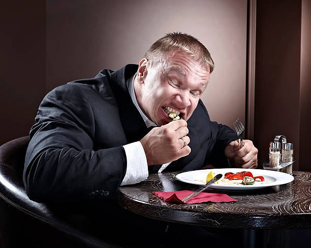 istock Muscular businessman eating 497488636