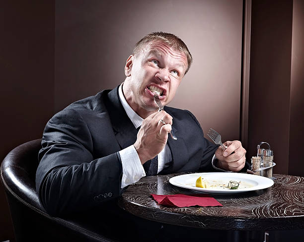 istock Muscular businessman eating 497488684