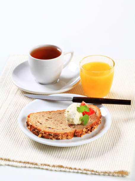 istock Bread with cheese spread, cup of tea and orange juice 497488815