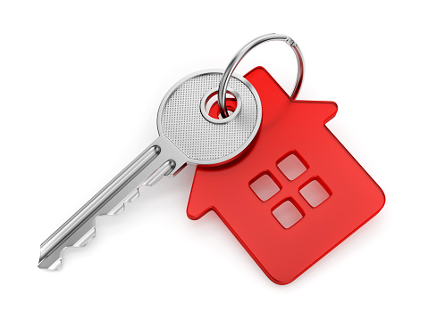 Metal door key with red house shaped key-chain isolated on white background