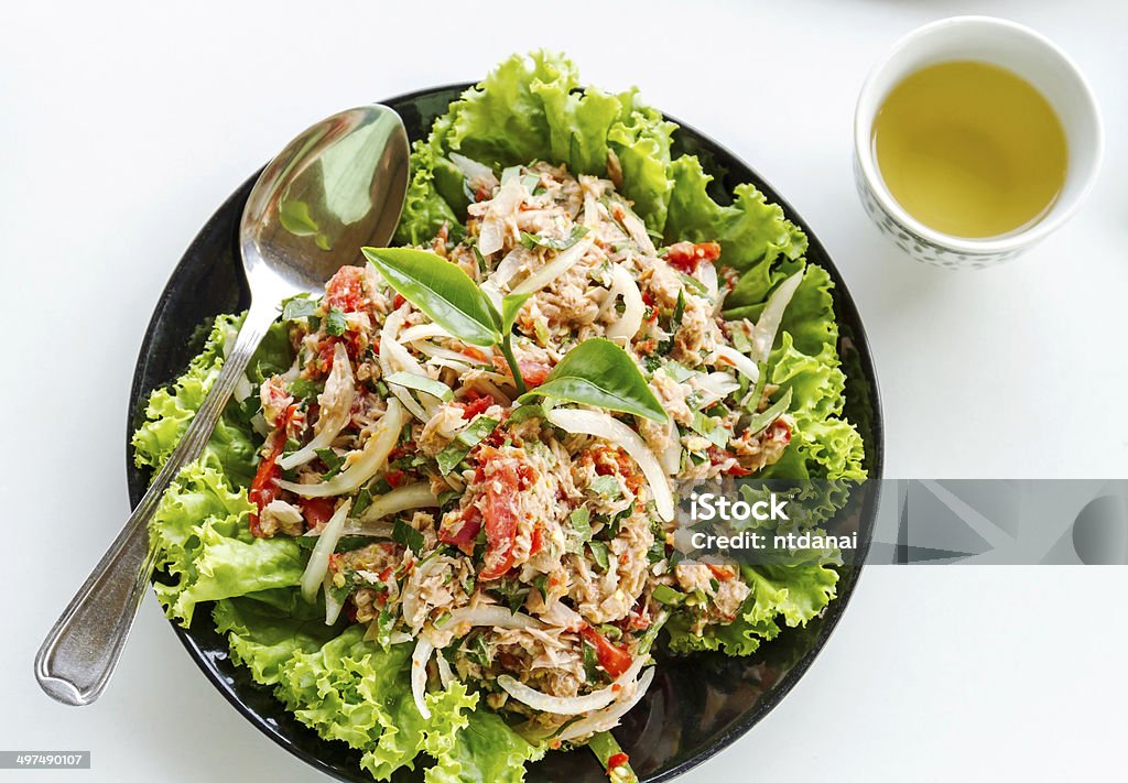 Salad of tuna fish Salad of tuna fish with fresh green tea leaves, Iceberg lettuce, tomato and chili isolated on white background Lettuce Stock Photo