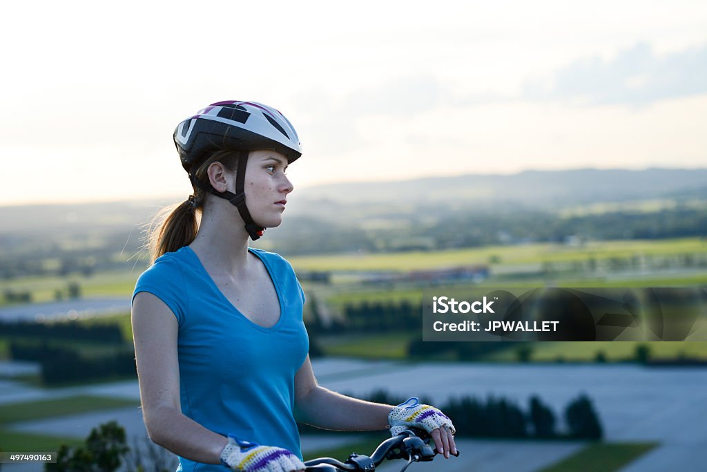 healthy cheerful young woman riding bicycle outdoor country lanscape healthy and cheerful young woman riding mountain bike outdoor in the country Active Lifestyle Stock Photo