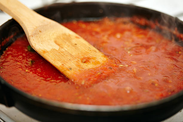 istock Boiling tomatoes sauce in the pan 497490188