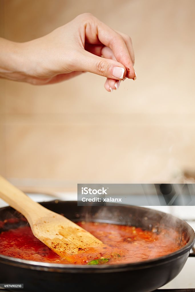 Boiling tomatoes sauce in the pan Closeup of boiling chopped tomatoes sauce in a pan on the stove, selective focus Cooking Pan Stock Photo