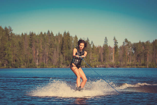 istock Young woman study riding wakeboarding on a lake 497490242