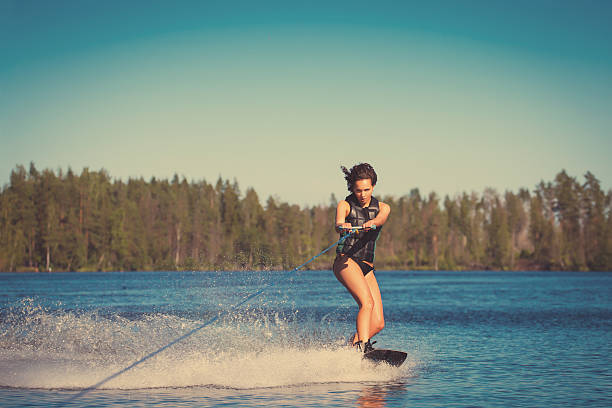 istock Young woman study riding wakeboarding on a lake 497490344
