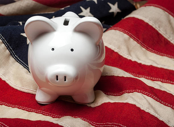Piggy bank on an American flag stock photo