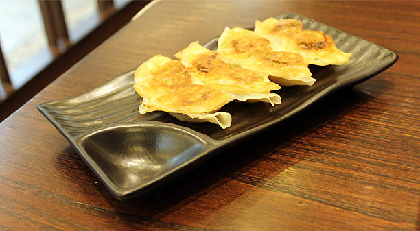 istock Gyoza dumplings on black dish 497492265