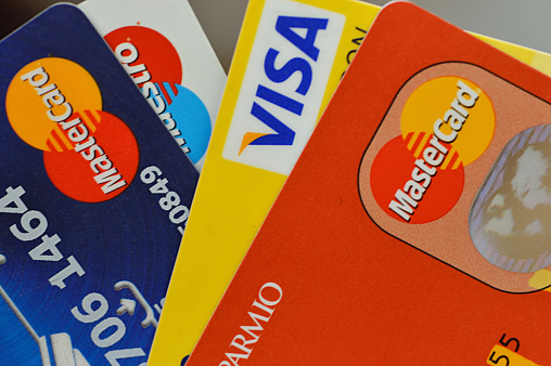 Hong Kong, China - September 22, 2013:  A close up of credit cards stack including visa, master and maestro