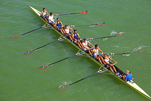 Seville, Spain - May 28, 2014: training of an eight on river Guadalquivir. The rowers are men and the cox is a woman.