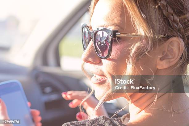 Young Beautiful Woman Uses Phone Stock Photo - Download Image Now - Car, Social Media, Teenage Girls