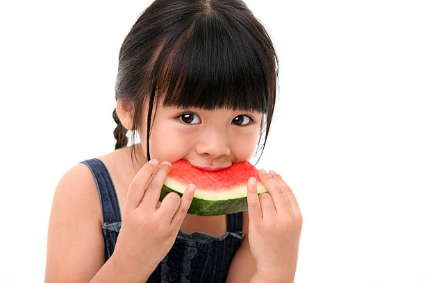 istock Happy little girl eating watermelon 497494753